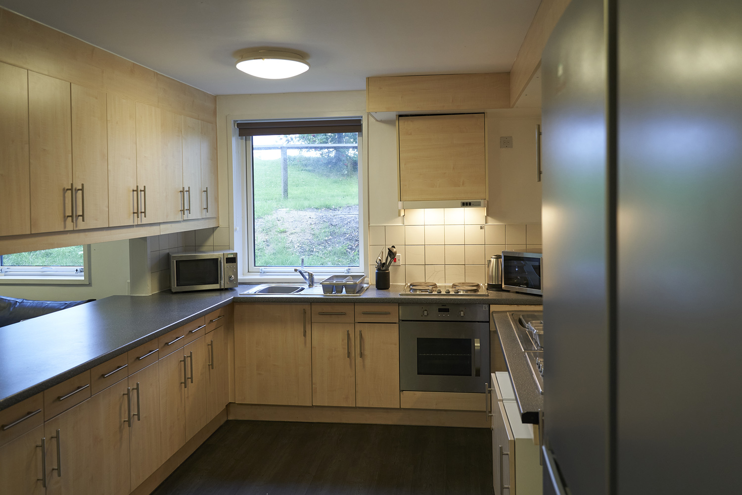 Large kitchen area with cooker and large fridge