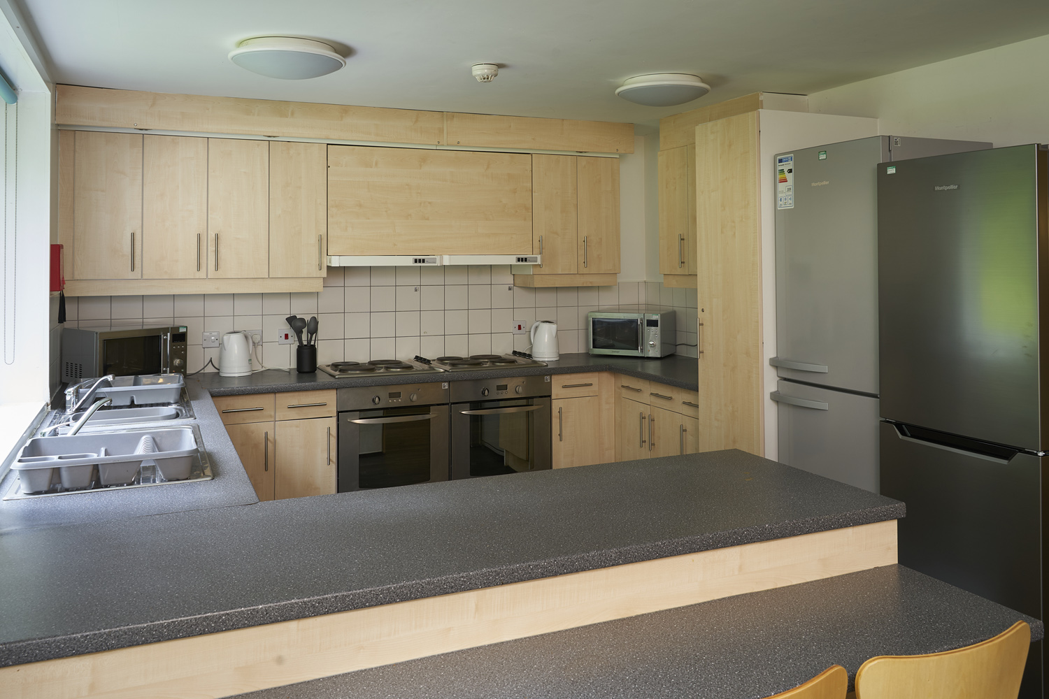 Large kitchen area view from bar stools