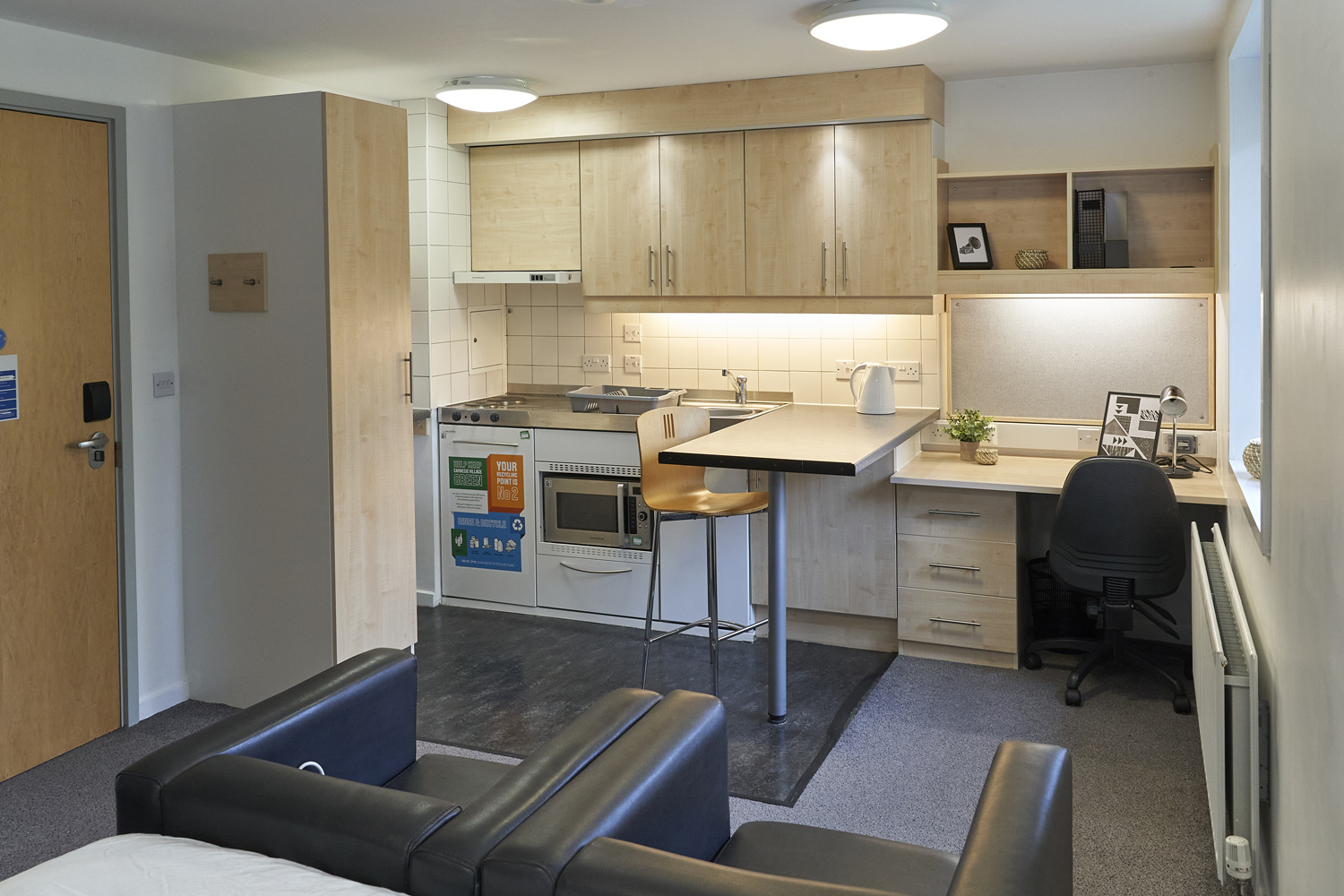 View from bed of studio kitchen space