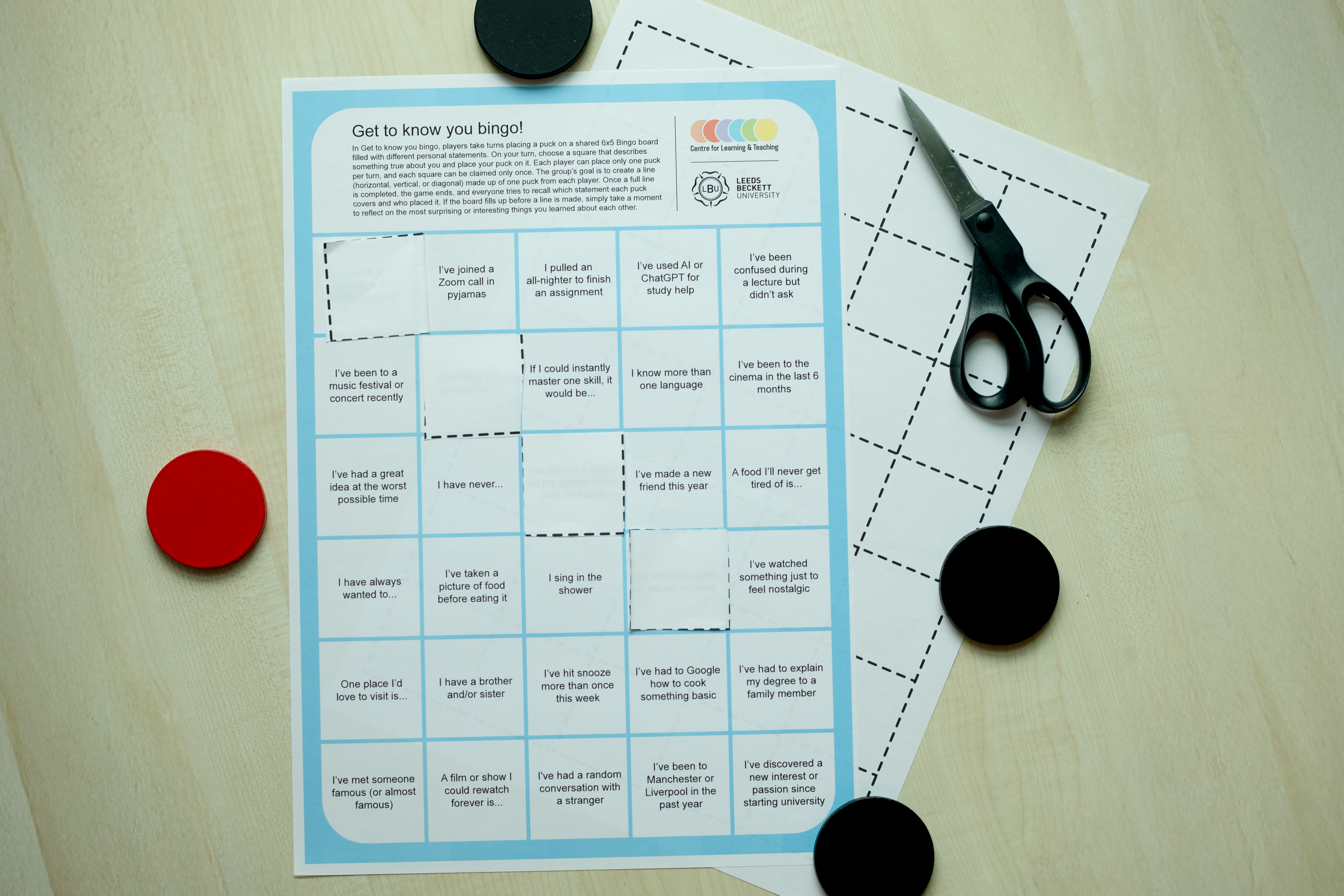 Image of bingo card with counters and scissors.