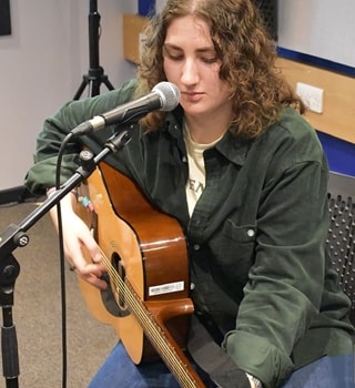 BA (Hons) Music Performance and Production student Ella sat down playing the guitar