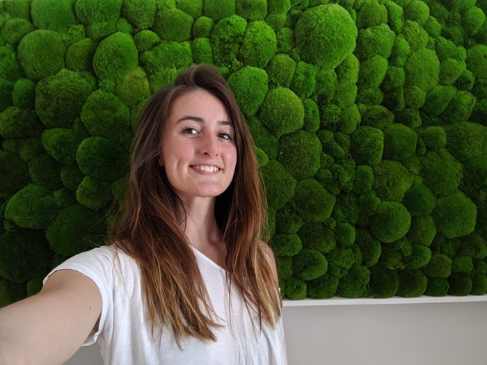 Young white woman with dark hair, wearing a white t-shit