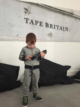 children stood in front of sign 'Tape Britain'