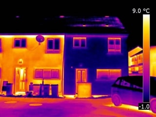 Thermal image showing houses with and without insulation