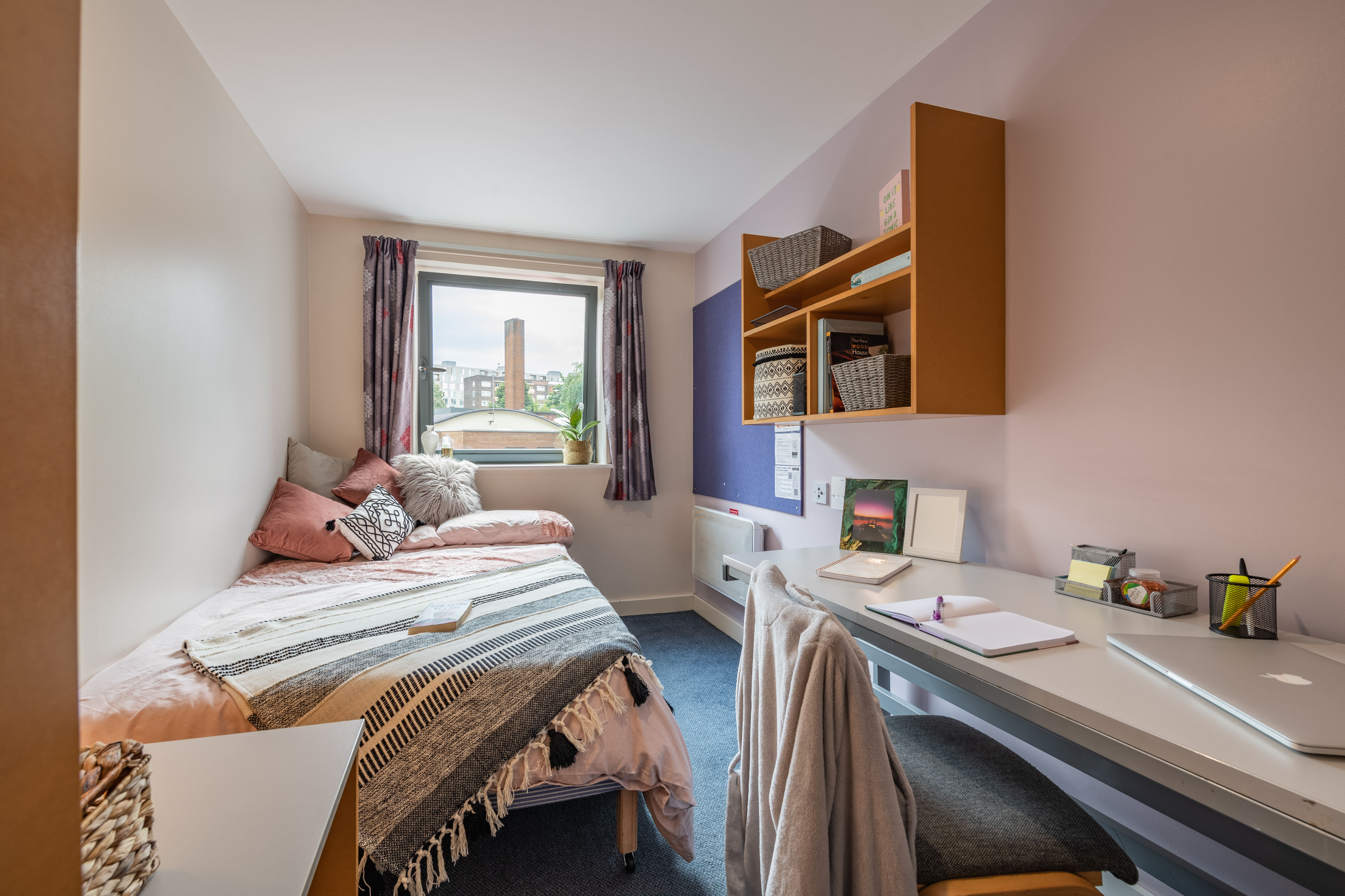 Single bed underneath the window in a standard bedroom