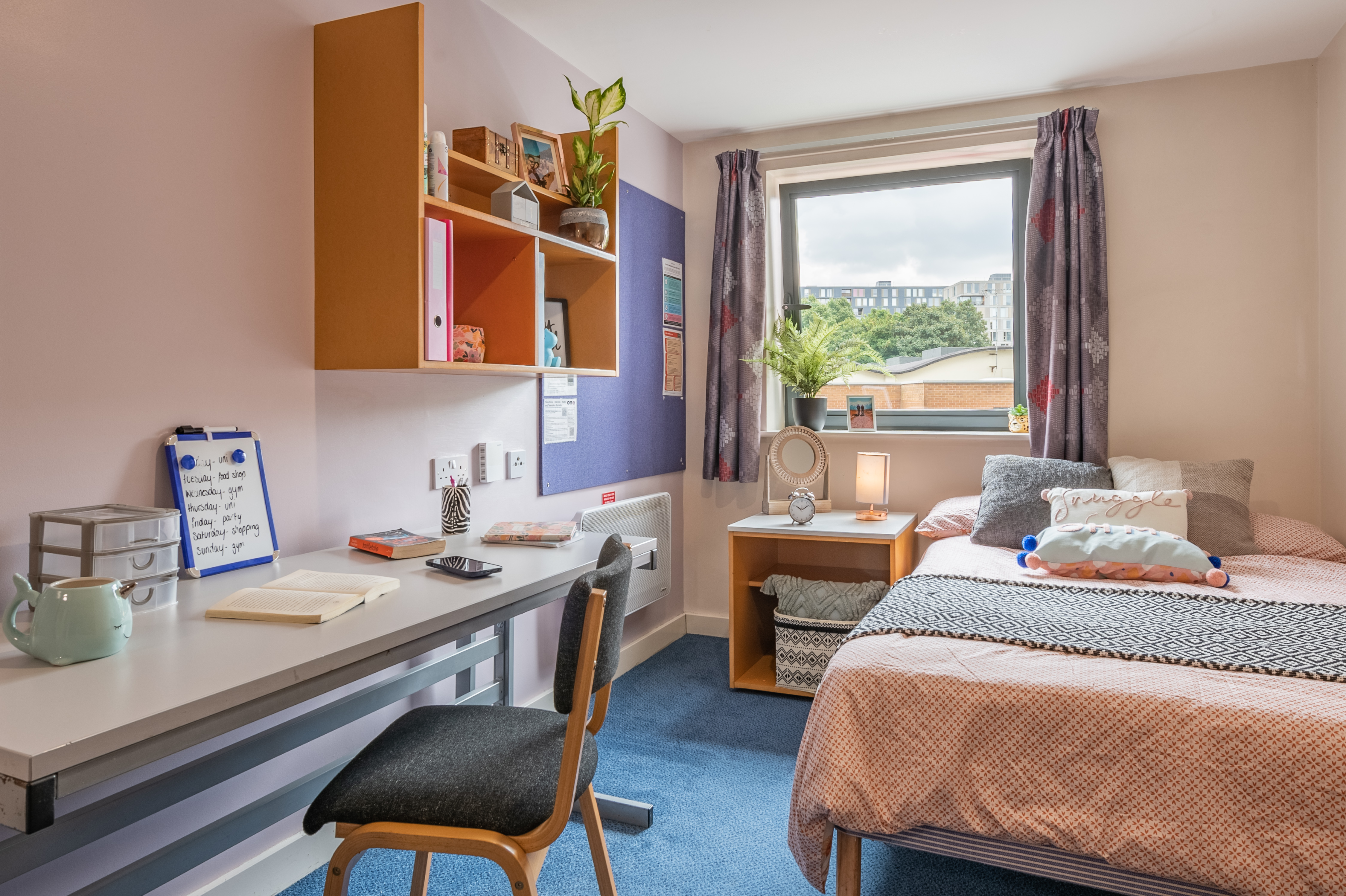 Light and airy view of the ensuite bedroom, with desk and table in the foreground