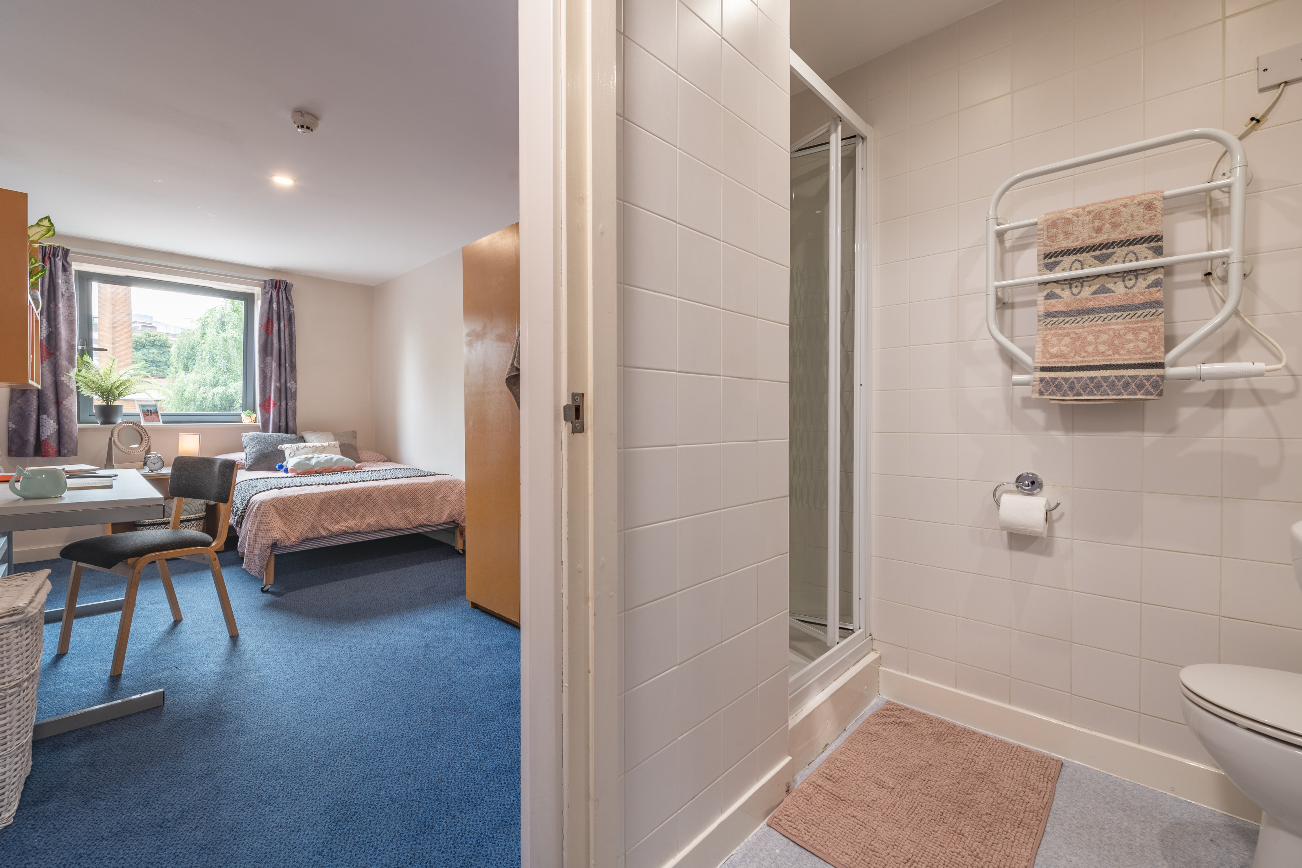 Light and airy view of the ensuite bedroom, with a look into the tiled ensuite bathroom