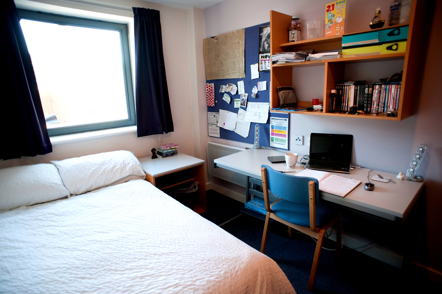 Mill street bedroom, double bed on the left, desk on the right, window in the background