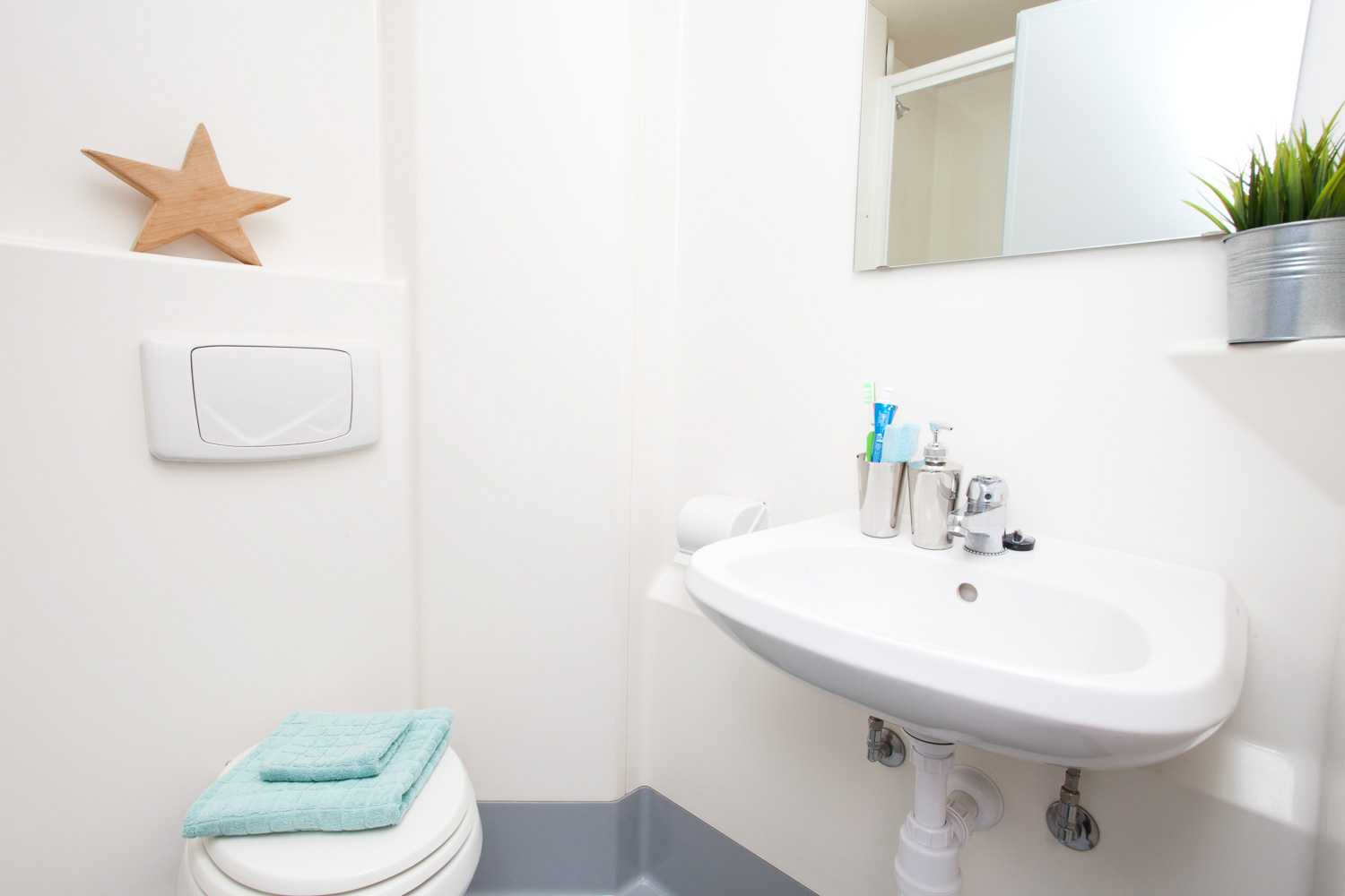 The Plaza bathroom with white walls sink and toilet