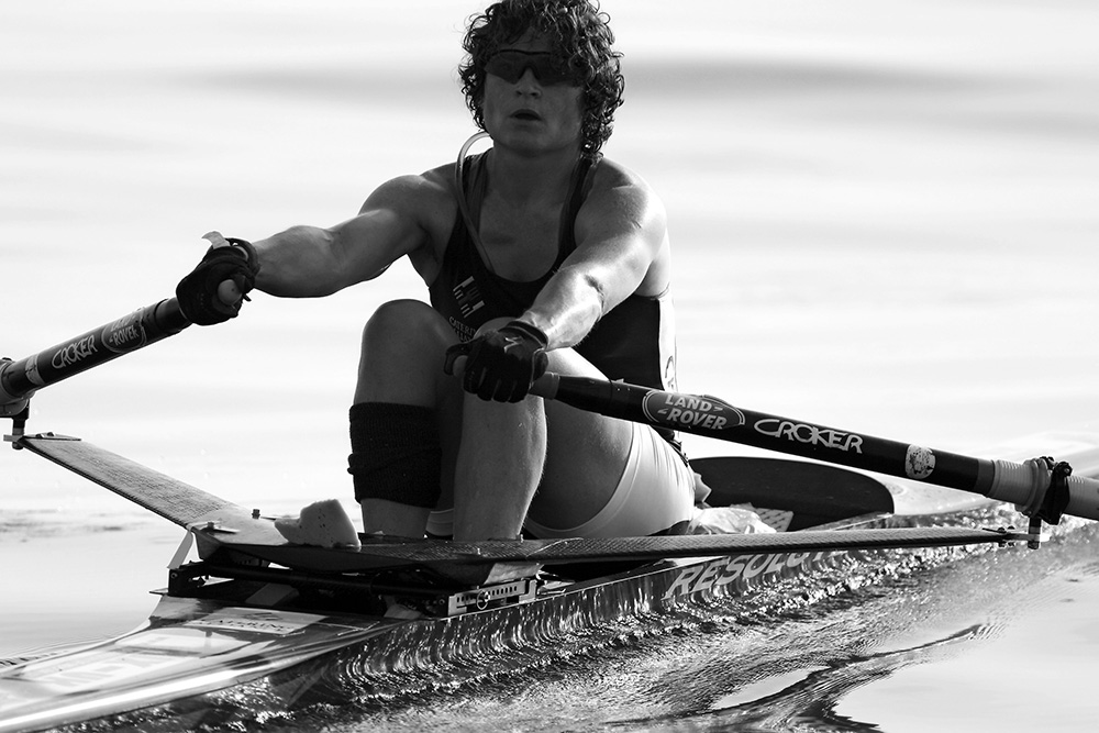 Black and white image of Guin Batten rowing