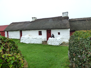 Image of cottage with garden and hedges