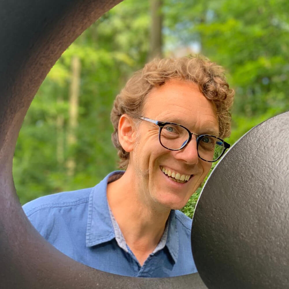 Dr Kiff Bamford Kneeling over a book